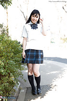 Student outdoors wearing uniform in plaid skirt wearing socks