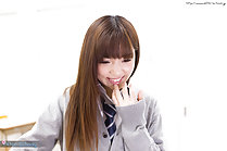 Student in uniform long hair hand raised to her lips