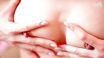 Hand on her small breasts hard nipples peeping out from between fingers