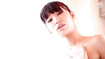Minami H with hand raised to her chest