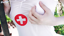 Machiko clutching her left breast wearing nurse outfit