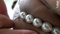 Beads obscuring her pussy lips
