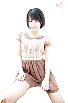 Sitting on sofa arm wearing dress short hair