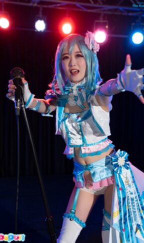Ria Kurumi standing at microphone lowering her panties