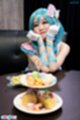 Sitting at dinner table propped up on her elbows