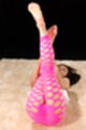 On her back legs raised in pink leggings bare feet