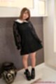 Playing with hem of her dress