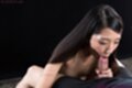 Long hair falling over her shoulder sucking cock head