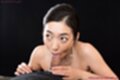 Looking up on her knees naked sucking cock head