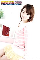 Sitting on couch short hair reaching down to her shoulders in pink striped top and yellow skirt