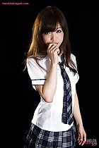Wearing uniform long hair over her shoulders hand raised to her mouth