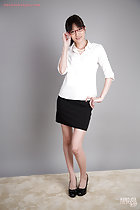Office lady wearing white shirt in short black skirt wearing high heels adjusting her glasses