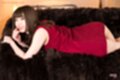 Katou tsubaki lying on sofa wearing red dress