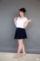Wearing white top black skirt high heels hands raised