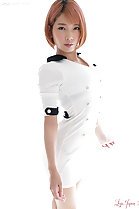 Standing beside window in white dress short hair