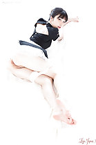 Lying in maid outfit looking over her shoulder panties around her thighs exposing her labia bare feet