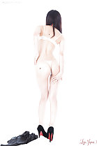 Rear view in bra and thong panties wearing high heels