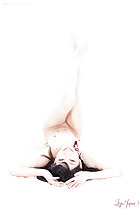 Lying on her back naked legs raised bare feet small tits
