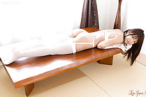 Shino Aoi lying on her front looking back nice ass white stockings