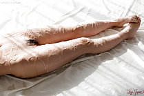 Legs covered in oil bare feet together pussy hair