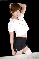 Oshiro Kaede standing with arm raised in short skirt wearing white stockings