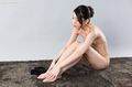 Kamimoto rio seated naked knees drawn up hands on her bare feet