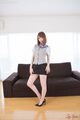 Kisaki aya standing in front of sofa hands on her thighs wearing high heels