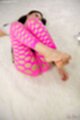 Lying on her back knees drawn up wearing pantyhose bare feet raised.jpeg