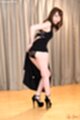 Looking back raising dress exposing panties in high heels