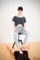 Looking down hands on her thighs in jeans giving footjob bare feet