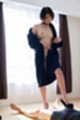 Overcoat off her shoulder small tits wearing high heels giving footjob