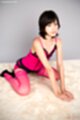 On her knees leaning forward short hair wearing lingerie in stockings high heels
