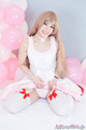 On her knees raising dress hem showing her panties wearing white stockings