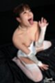 On her knees looking up mouth open tongue out wearing white basque in stockings