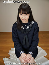 Seated in uniform long hair over her shoulders hands together on her knees