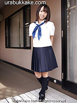 Standing outside home wearing seifuku uniform hands behind her back