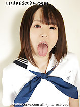 Extending her tongue wearing sailor suit uniform